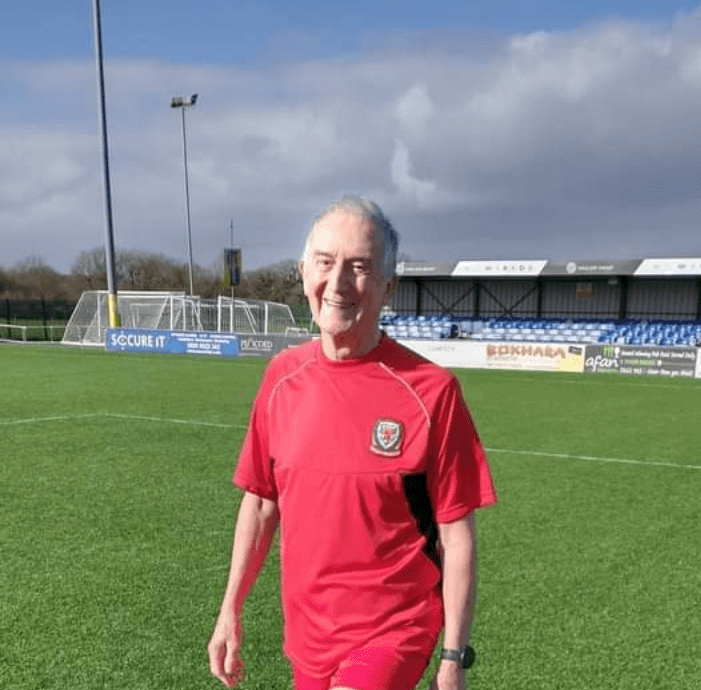 Veteran footballer Keith Beardmore on the pitch with a ball.