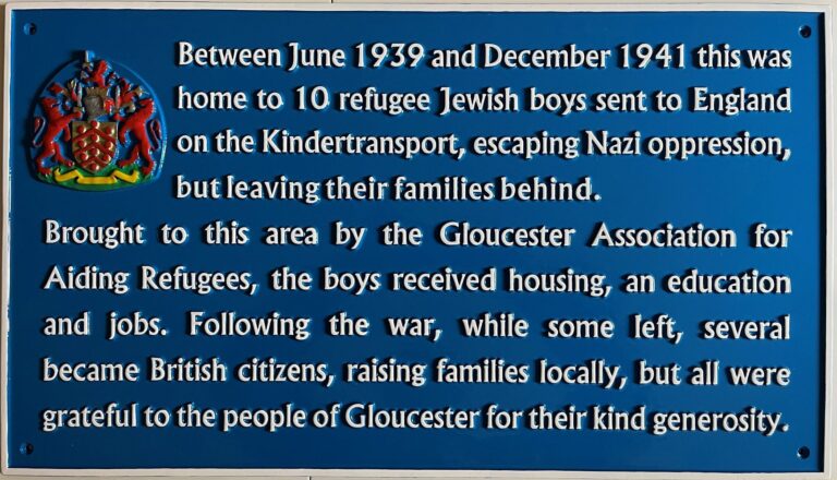 Blue plaque on 18 Alexandra Road honouring the 10 refugee Jewish boys who lived there. It reads: Between June 1939 and December 1941 this was home to 10 refugee Jewish boys sent to England on the Kindertransport, escaping Nazi oppression, but leaving their families behind. Brought to this area by Gloucester Association for Aiding Refugees, the boys received housing, an education and jobs. Following the war, while some left, several became British citizens, raising families locally, but all were grateful to the people of Gloucester for their kind generosity.