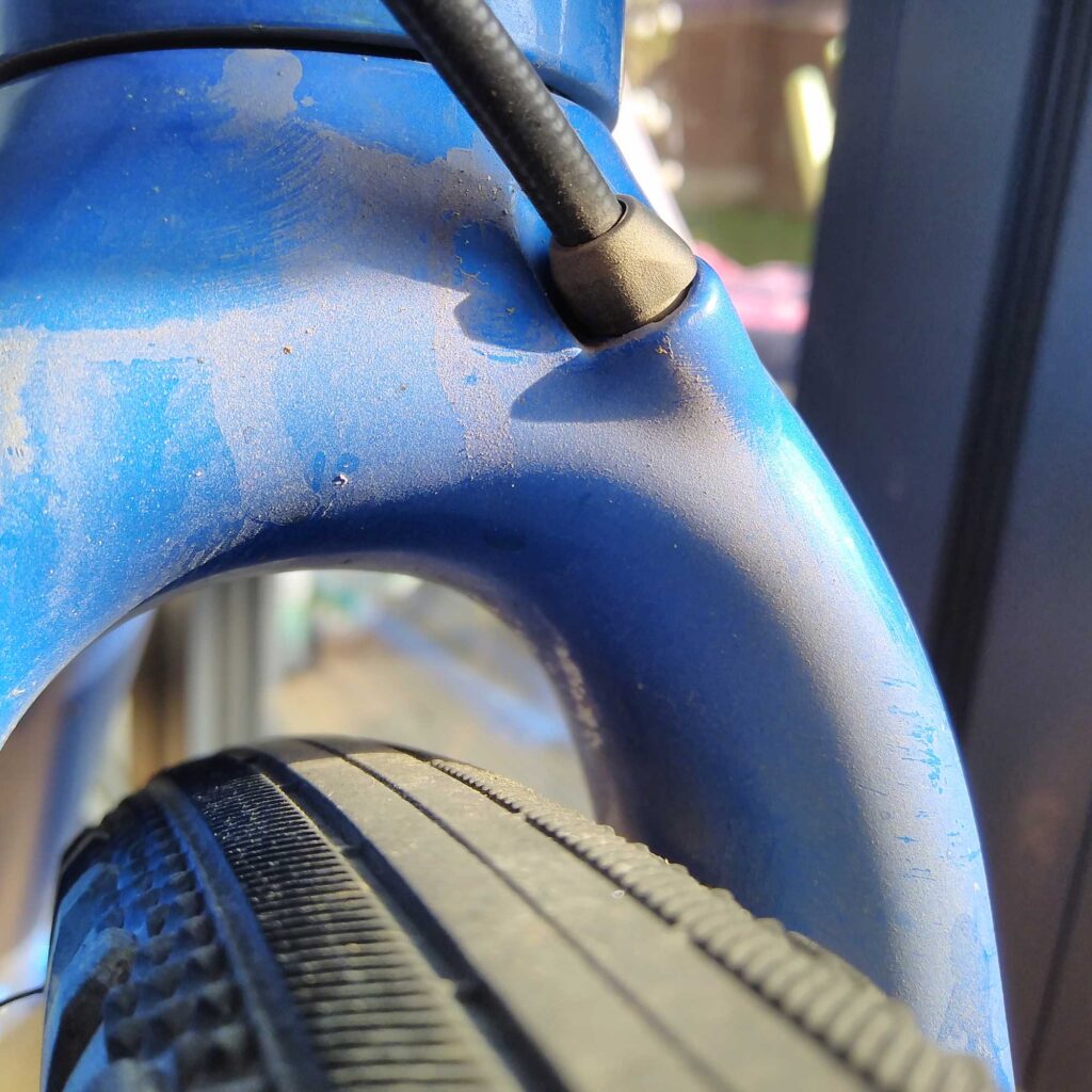 A close-up image of a bicycle tyre and frame.