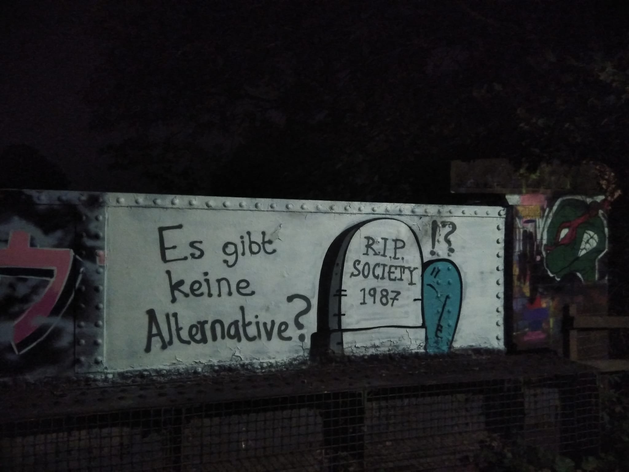 Photo of graffiti showing a cartoon and text in a foreign language.