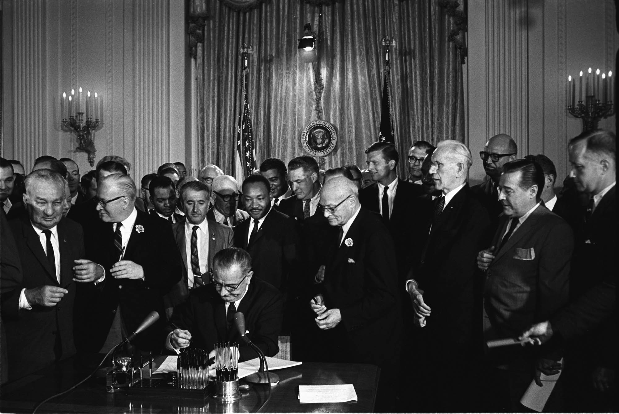 Lyndon Johnson at the signing of the Civil Rights Act on July 2nd 1964 with Martin Luther King Jr present.